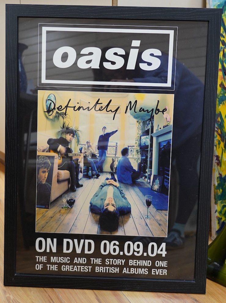 A framed Oasis Definitely Maybe DVD poster, 69 x 49cm. Condition - good